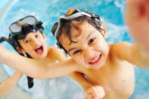 kids swimming and having a healthy summer